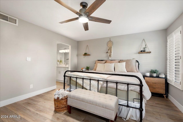 bedroom with connected bathroom, ceiling fan, and hardwood / wood-style floors