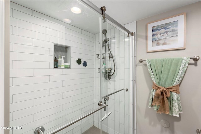 bathroom with a shower with door