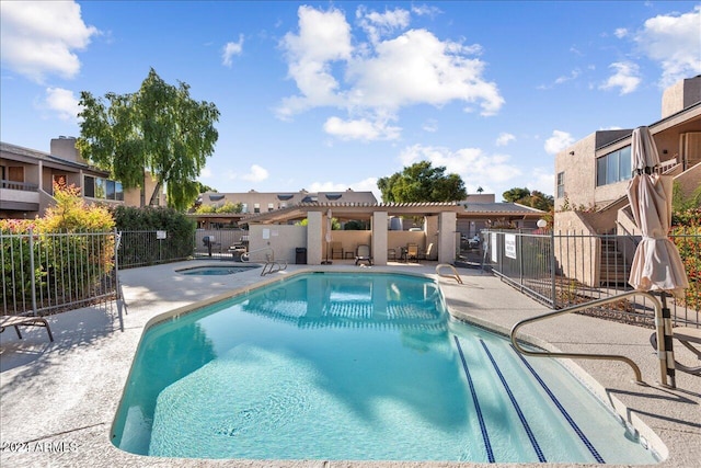 view of swimming pool with a community hot tub and a patio