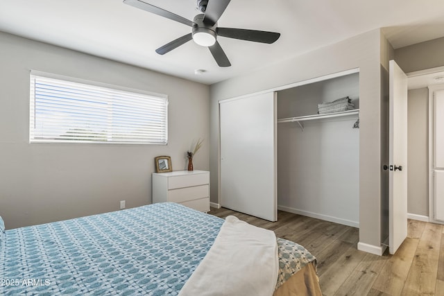 bedroom featuring ceiling fan, a closet, and light hardwood / wood-style flooring