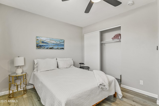 bedroom featuring a closet, hardwood / wood-style floors, and ceiling fan