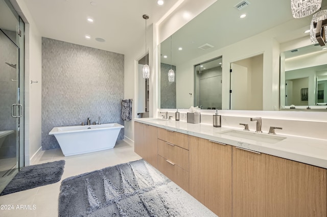 bathroom featuring tile patterned flooring, vanity, and plus walk in shower