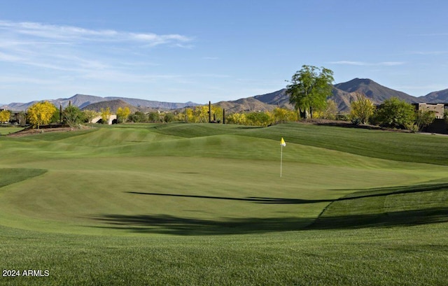 view of property's community with a mountain view and a lawn