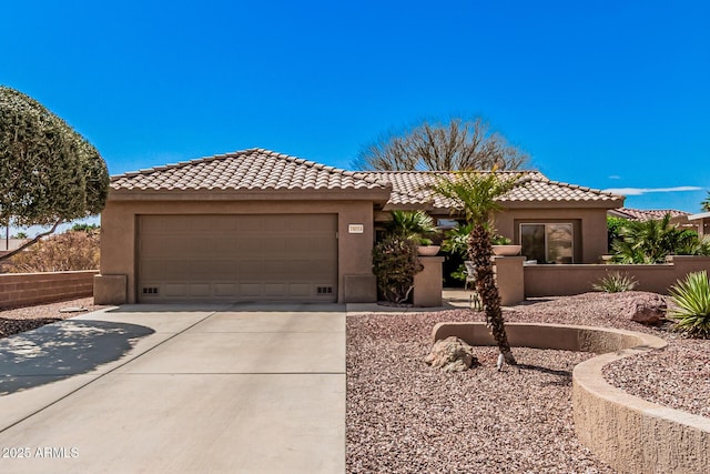 view of front of property featuring concrete driveway, a tiled roof, and stucco siding