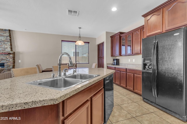 742 E Kingbird Dr, Gilbert, AZ 85297 - kitchen with black appliances, light countertops, light tile patterned floors, pendant lighting, and a kitchen island with sink