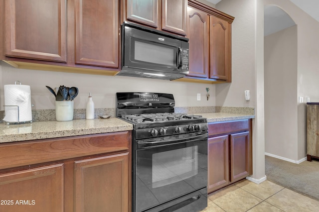 742 E Kingbird Dr, Gilbert, AZ 85297 - kitchen featuring black appliances, light tile patterned flooring, light stone counters, light colored carpet, and arched walkways