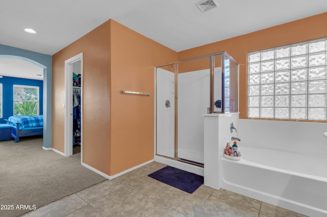 742 E Kingbird Dr, Gilbert, AZ 85297 - bathroom with a stall shower, a bath, tile patterned floors, and a walk in closet