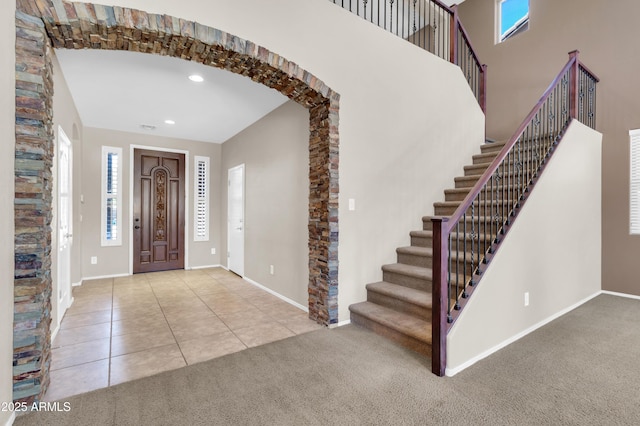 742 E Kingbird Dr, Gilbert, AZ 85297 - carpeted entryway with arched walkways, stairway, recessed lighting, and tile patterned floors