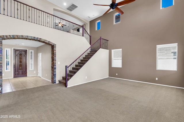 742 E Kingbird Dr, Gilbert, AZ 85297 - entrance foyer featuring a ceiling fan, carpet, stairs, a high ceiling, and arched walkways