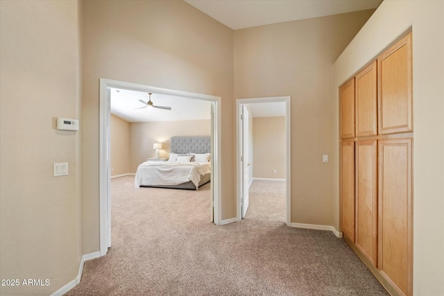 bedroom featuring baseboards and light carpet
