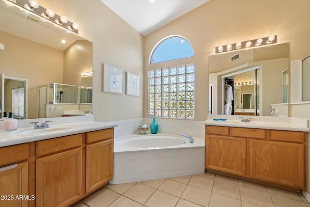 full bathroom featuring a bath, visible vents, a stall shower, a sink, and tile patterned floors