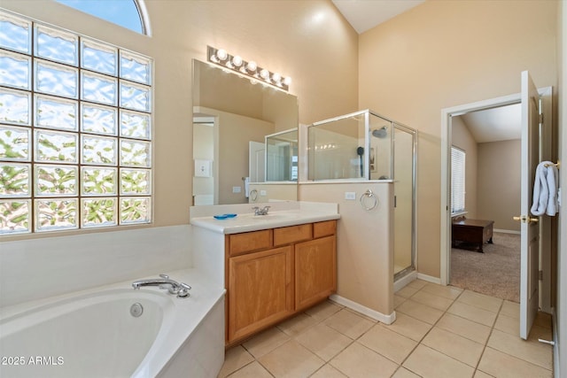 bathroom featuring plenty of natural light, tile patterned flooring, and a shower stall