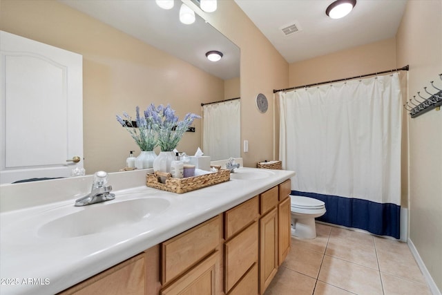 full bathroom with a sink, tile patterned floors, toilet, and double vanity