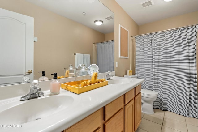 bathroom featuring a sink, tile patterned floors, double vanity, and visible vents