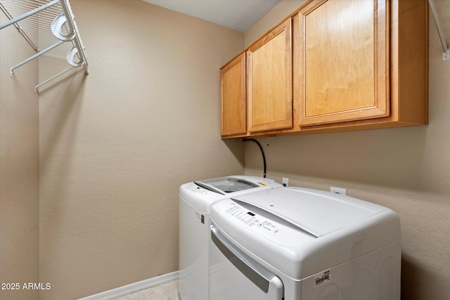 laundry room with cabinet space and washing machine and dryer