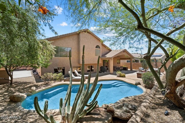 view of pool featuring a fenced backyard, a fenced in pool, and a patio area
