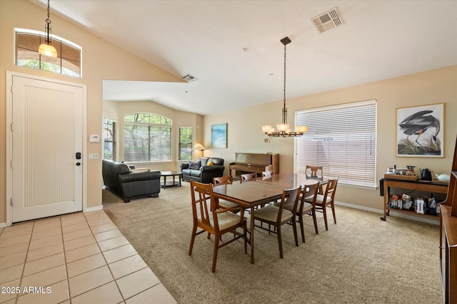 dining space featuring light colored carpet, a chandelier, baseboards, lofted ceiling, and visible vents