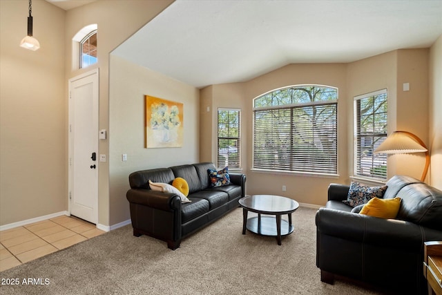 carpeted living area with baseboards, vaulted ceiling, and a wealth of natural light