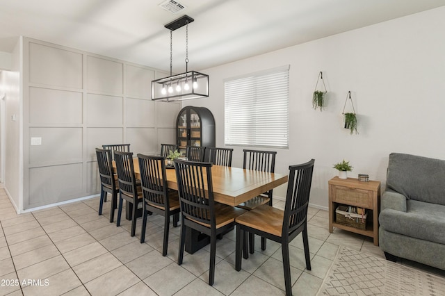 dining space featuring light tile patterned floors and visible vents