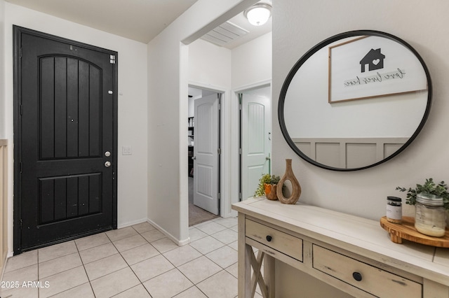 foyer entrance with light tile patterned floors