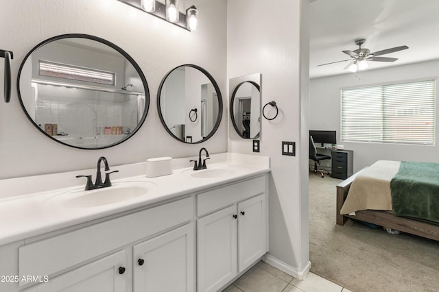 full bath featuring double vanity, tile patterned floors, ensuite bathroom, and a sink