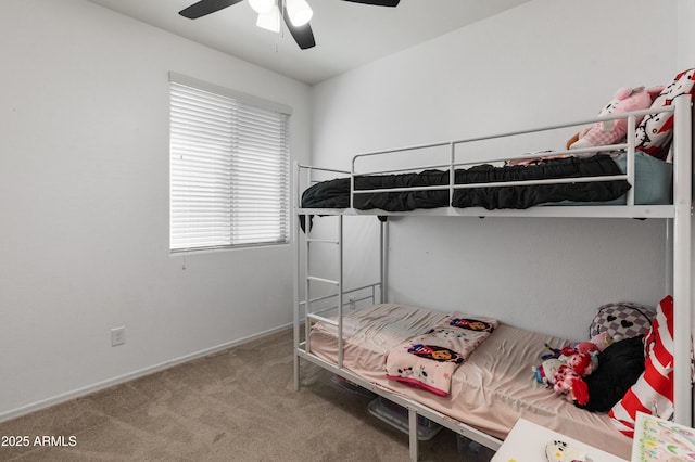 carpeted bedroom with baseboards and a ceiling fan