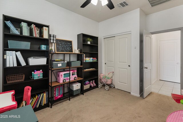 interior space with visible vents, carpet flooring, and ceiling fan