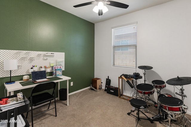 carpeted home office featuring baseboards and ceiling fan