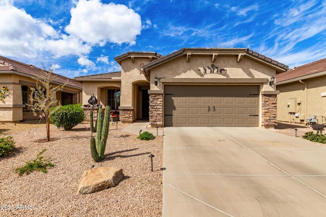 mediterranean / spanish-style house with an attached garage, stone siding, driveway, and stucco siding