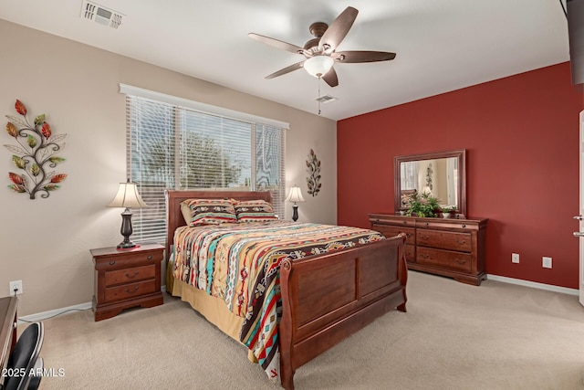 bedroom with visible vents, light carpet, and baseboards