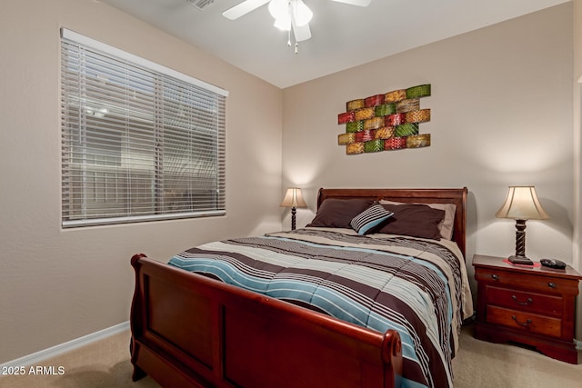 carpeted bedroom featuring ceiling fan and baseboards