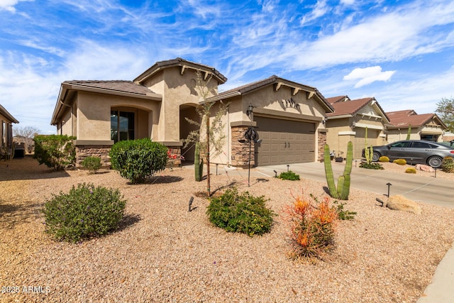 view of front of property featuring a tiled roof, concrete driveway, stucco siding, stone siding, and an attached garage