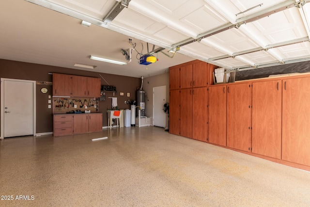 garage featuring water heater and a garage door opener