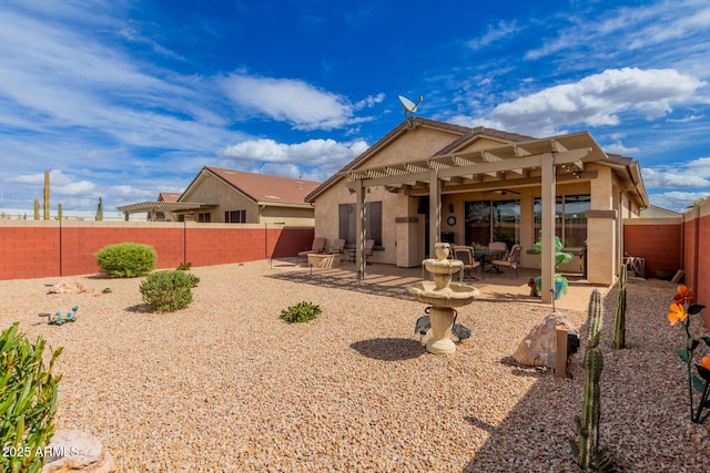 back of property featuring a patio area, stucco siding, a ceiling fan, and a fenced backyard