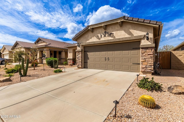 view of front facade featuring stucco siding, driveway, a gate, stone siding, and a garage