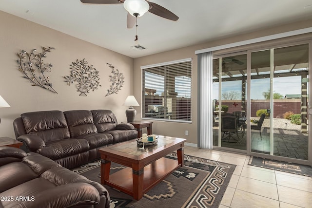 tiled living room with visible vents and ceiling fan