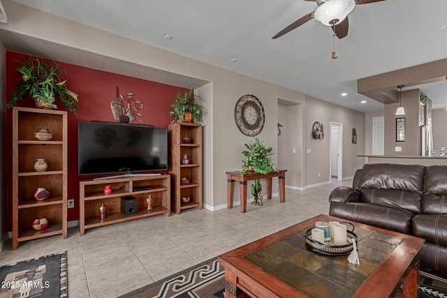 living room with light tile patterned floors, recessed lighting, baseboards, and ceiling fan