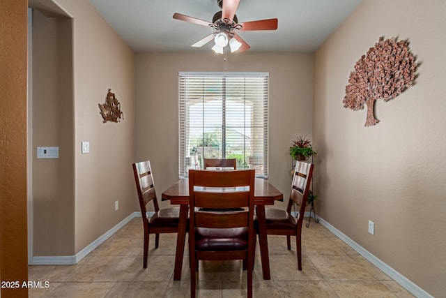 dining space featuring light tile patterned floors, baseboards, and ceiling fan