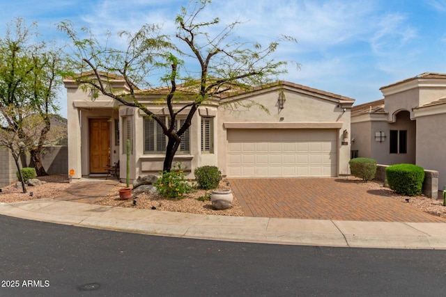 12841 N 19th St, Phoenix, AZ 85022 - view of front facade with decorative driveway, a garage, and stucco siding