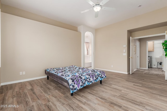 12841 N 19th St, Phoenix, AZ 85022 - bedroom featuring arched walkways, ceiling fan, baseboards, and light wood-style floors