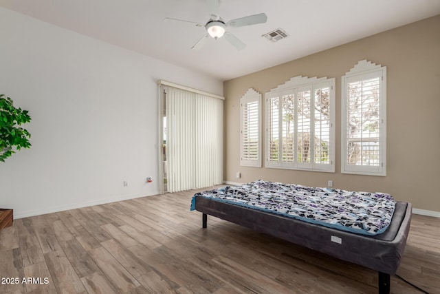 12841 N 19th St, Phoenix, AZ 85022 - bedroom featuring baseboards, ceiling fan, visible vents, and wood finished floors