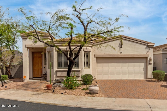 12841 N 19th St, Phoenix, AZ 85022 - view of front of house with decorative driveway, stucco siding, and an attached garage