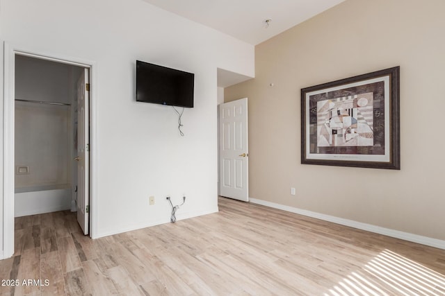 12841 N 19th St, Phoenix, AZ 85022 - unfurnished bedroom with baseboards, a closet, wood finished floors, and a walk in closet