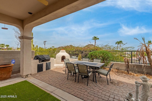 12841 N 19th St, Phoenix, AZ 85022 - view of patio featuring a grill, fence, exterior fireplace, exterior kitchen, and outdoor dining space