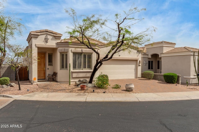 12841 N 19th St, Phoenix, AZ 85022 - mediterranean / spanish-style house featuring stucco siding, decorative driveway, a garage, and fence