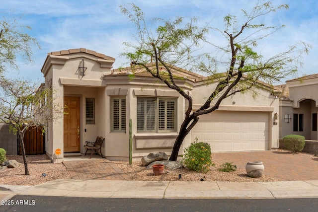 12841 N 19th St, Phoenix, AZ 85022 - mediterranean / spanish home featuring stucco siding, a garage, fence, and decorative driveway