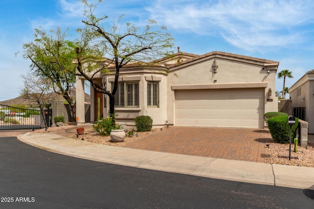 12841 N 19th St, Phoenix, AZ 85022 - mediterranean / spanish home featuring stucco siding, an attached garage, fence, and decorative driveway