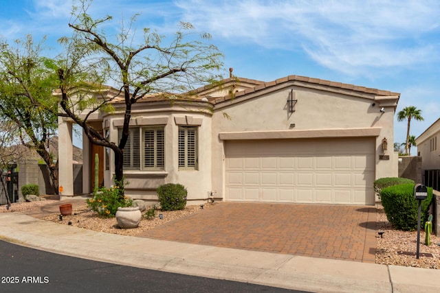 12841 N 19th St, Phoenix, AZ 85022 - mediterranean / spanish house with stucco siding, a garage, fence, and decorative driveway