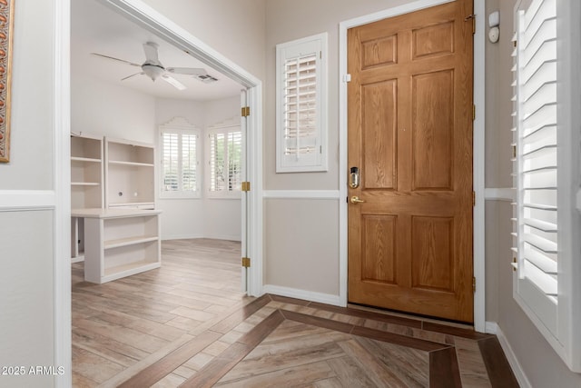 12841 N 19th St, Phoenix, AZ 85022 - foyer entrance with baseboards, visible vents, ceiling fan, and parquet floors