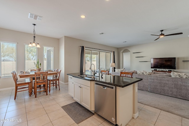 kitchen with decorative light fixtures, dark countertops, visible vents, a sink, and dishwasher